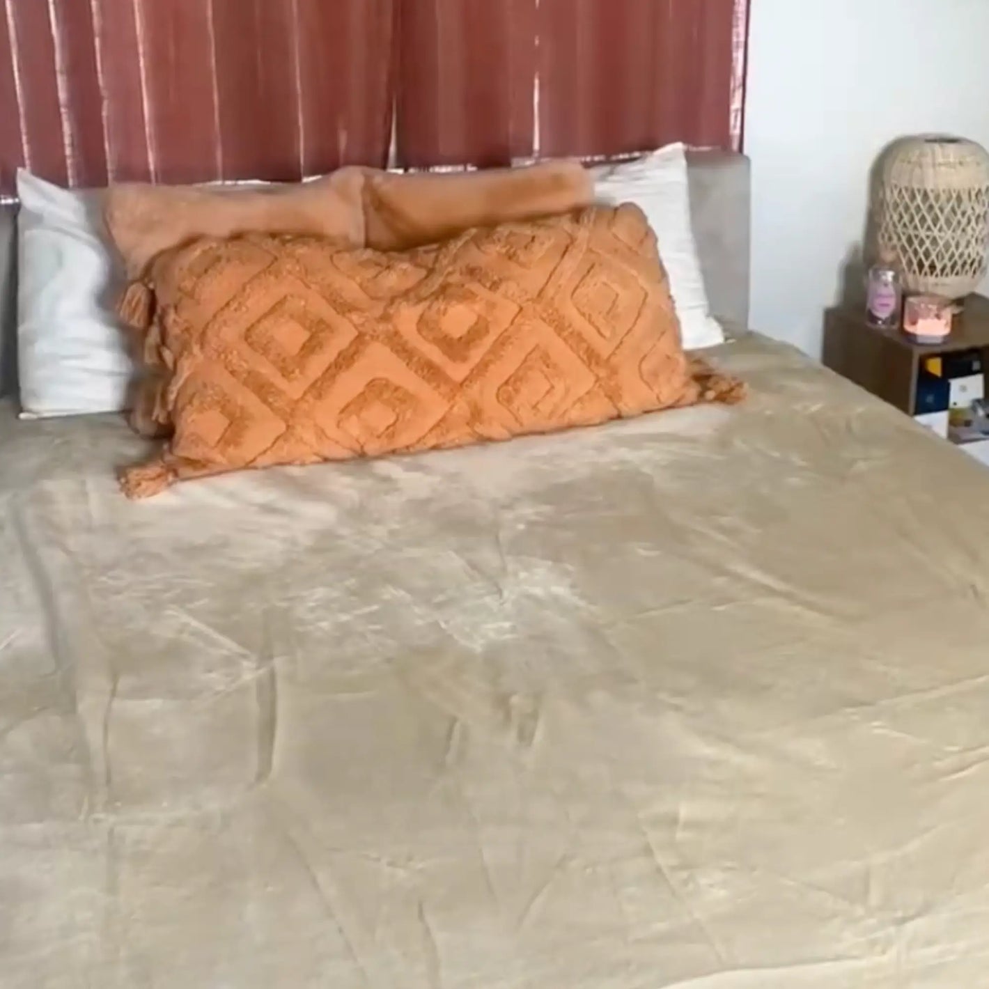 Review with a beige LoveBlanket on a bed 