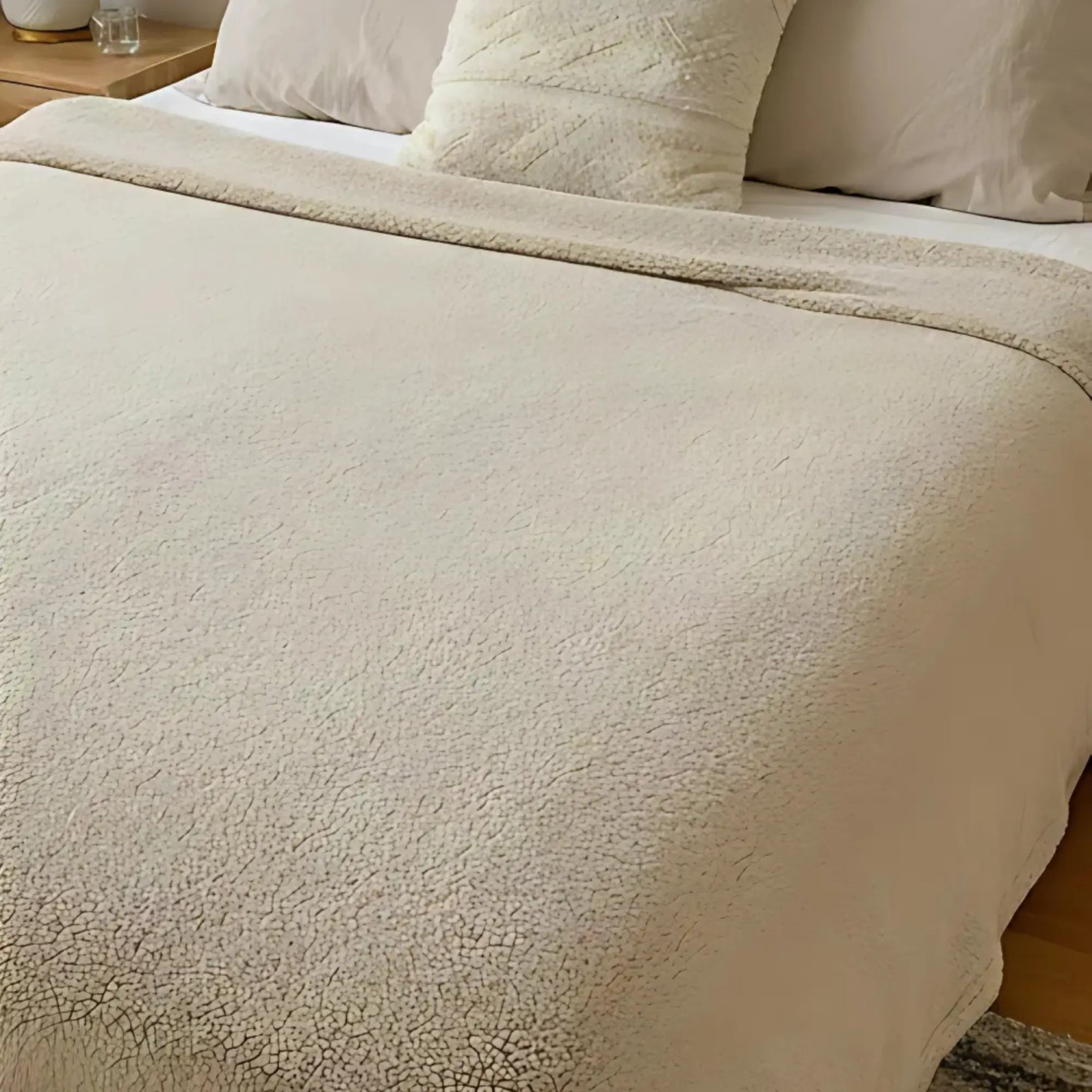 Review with a beige LoveBlanket on a bed